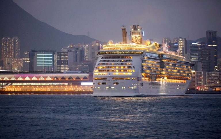 FILE - In this Wednesday, June 12, 2013, file photo, the Mariner of the Seas, right, one of the Voyager-class vessels of Royal Caribbean International, docks at Kai Tak Cruise Terminal in Hong Kong's Victoria Harbor. Royal Caribbean Cruises reports quarterly financial results before the market open on Monday, Jan. 27, 2014.  (AP Photo/Kin Cheung, File)