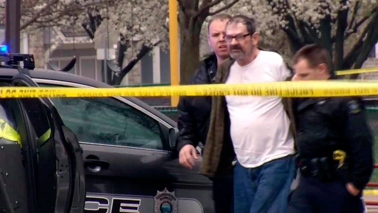 Frazier Glenn Miller Jr. is escorted by police after allegedly perpetrating a shooting, in Overland Park, Kan., on Sunday. (AP Photo/KCTV-5)