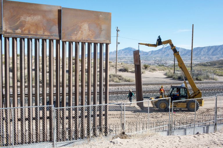 Workers use a crane to lift a segment of a new fence into place on the U.S. side of the border with Mexico, where Sunland Park, New Mexico, meets the Anapra neighborhood of Ciudad Juarez, Mexico. (AP Photo/Rodrigo Abd)