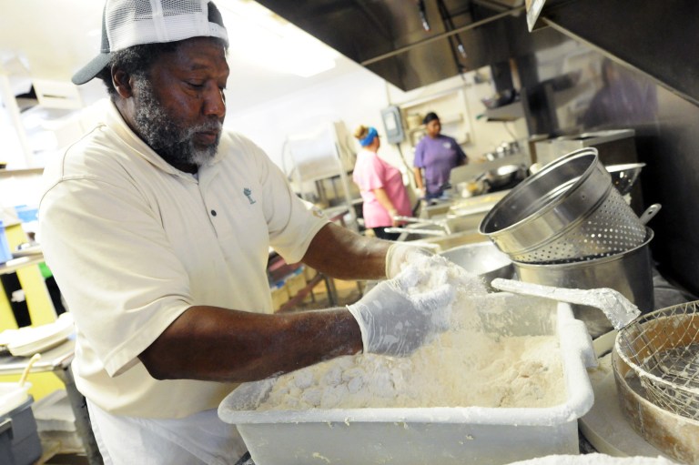In this Sept. 17, 2014 photo, Andy Gause breads shrimp in the kitchen of the Calabash Seafood Hut in Calabash, N.C. The Institute for Supply Management releases its service sector index for September on Friday, Oct. 3, 2014. (AP Photo/The Star-News, Matt Born)  LOCAL TELEVISION OUT; LOCAL INTERNET OUT