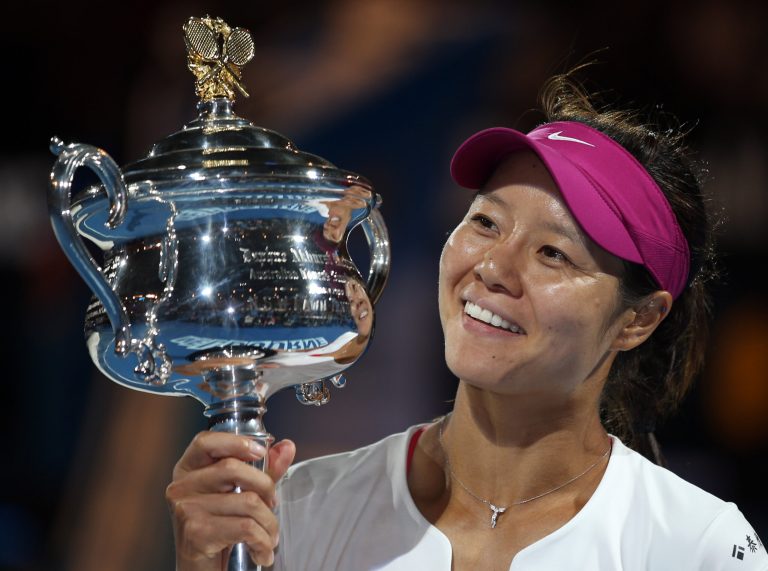 FILE - In this Jan. 25, 2014 file photo, Li Na of China holds the championship trophy after defeating Dominika Cibulkova of Slovakia in their women's singles final at the Australian Open tennis championship in Melbourne, Australia. Li, a two-time Grand Slam champion from China who took tennis in Asia to a new level, announced her retirement on Friday, Sept. 19, 2014. (AP Photo/Rick Rycroft, File)