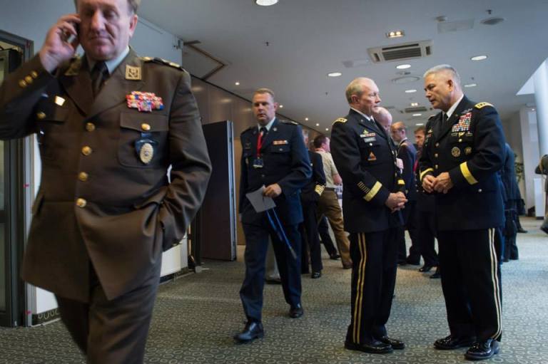 Army Gen. Martin E. Dempsey, chairman of the Joint Chiefs of Staff, center, talks with Army Gen. John Campbell, commander of the International Security Assistance Force in Afghanistan, right, between sessions of the NATO Military Committee conference in Vilnius, Lithuania, held Sept. 20-21, 2014. (DoD photo by D. Myles Cullen)