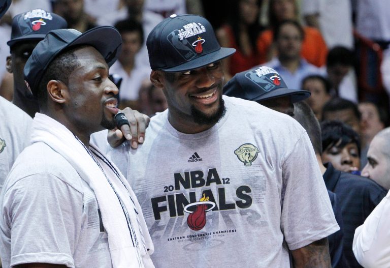   Miami Heat's Dwyane Wade, left, and LeBron James stand together during the trophy presentation following the Heat's 101-88 victory over the Boston Celtics in Game 7 in the NBA basketball Eastern Conference Finals playoff series, Saturday, June 9, 2012, in Miami. (AP Photo/Lynne Sladky)  
