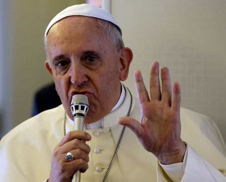 Pope Francis speaks to the media during an airborne press conference on his journey back to Rome from Seoul, South Korea, Monday, Aug. 18, 2014. (AP Photo/Gregorio Borgia)
