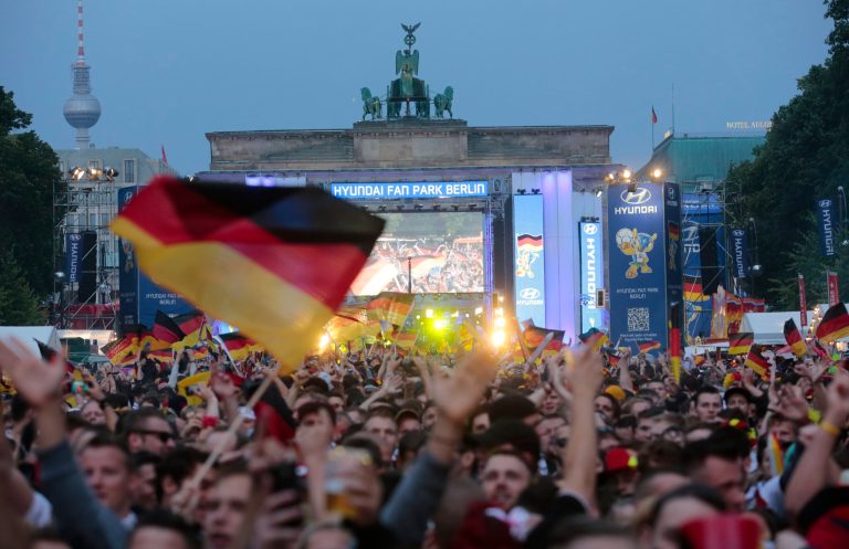 Thousands of German soccer fans wait for the live broadcast of the final match  between Germany and Argentina at the soccer World Cup in Rio de Janeiro, Brazil,  at a public viewing area called 'Fan Mile' in front of the Brandenburg Gate in Berlin, Sunday, July 13, 2014. (AP Photo/Markus Schreiber)