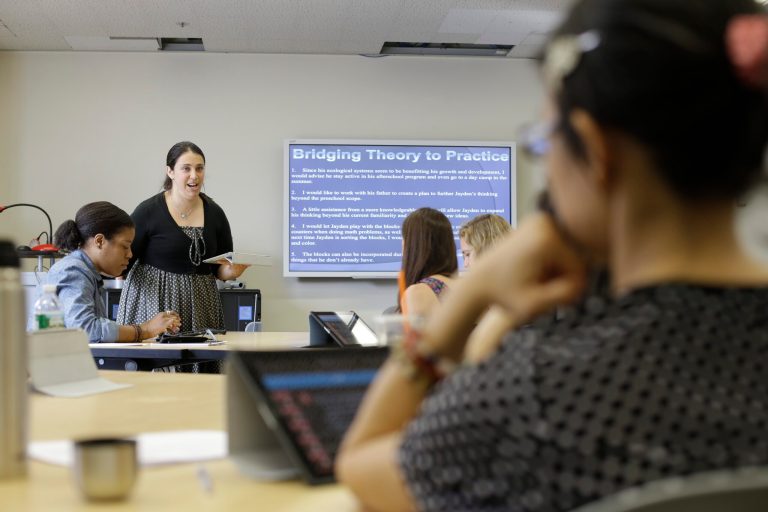 In a Wednesday, June 25, 2014 photo, Dr. Lyndsay Portnoy leads a class in early childhood development at Hunter College as part of a push to expand pre-K under the program championed by New York City Mayor Bill de Blasio, in New York. Hundreds of new pre-K teachers are being trained in an intensive summer program.  (AP Photo/Frank Franklin II)