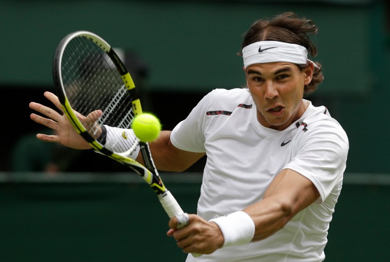   FILE - This June 26, 2012 file photo shows Rafael Nadal of Spain returning a shot to Thomaz Bellucci of Brazil during a first round men's singles match at the All England Lawn Tennis Championships at Wimbledon, England. Nadal has confirmed he is ready to return to competitive tennis at the end of the month in an exhibition tournament in Abu Dhabi, following a six-month break to recover from a knee injury. The 11-time Grand Slam champion said on his Facebook page Tuesday, Dec. 11, 2012, that he 