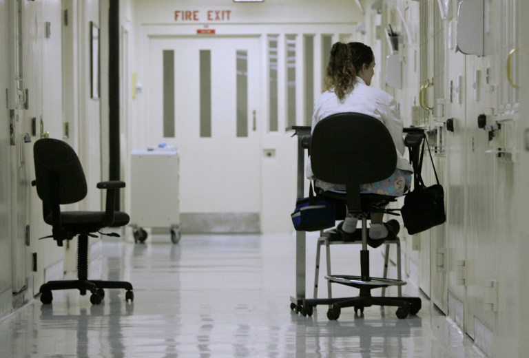 File - In this March 30, 2007 file photo, medical worker Theresa Wilks keeps a vigil outside an isolation cell containing an inmate who authorities fear might attempt suicide, at California State Prison, Sacramento, in Folsom, Calif. Under federal court oversight, California's prison mental health system has been spending far more on anti-psychotic drugs than similar states, raising questions about whether patients are receiving proper treatment. Figures compiled by The Associated Press show that California has been spending a far greater percentage on anti-psychotic medication for inmates than other states with large prison systems. (AP Photo/Rich Pedroncelli, file)