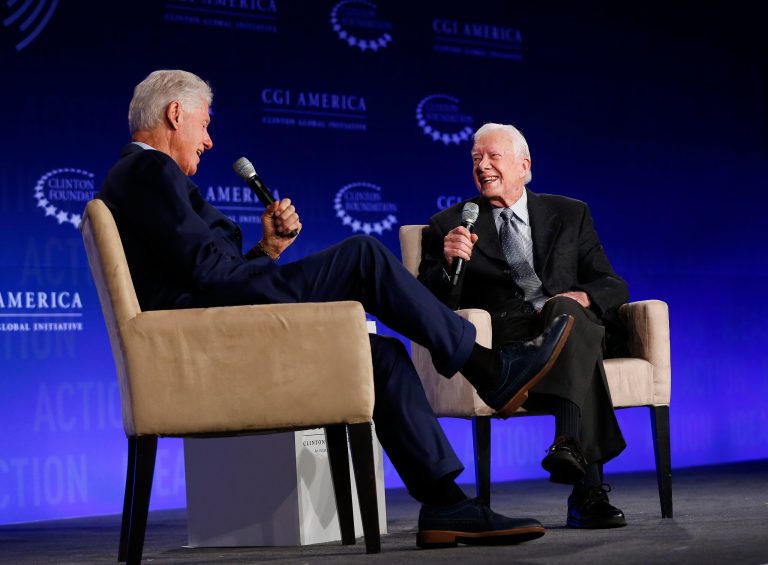 Former President Bill Clinton, left, speaks with former President Jimmy Carter at a Clinton Global Initiative meeting Tuesday, June 14, 2016, in Atlanta. (AP Photo/John Bazemore)