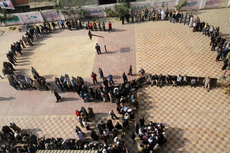   Egyptians wait in line to cast their votes during a referendum on a disputed constitution drafted by Islamist supporters of President Morsi in Cairo, Egypt, Saturday, Dec. 15, 2012. (AP Photo/Ahmed Gomaa)  