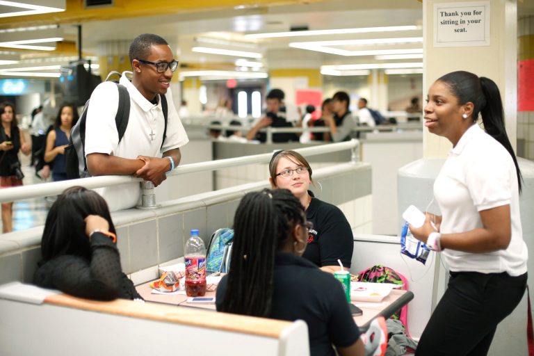 Student Quentin Cooper, 18, left, speaks with friends during lunch on the first day of school at South Philadelphia High School Monday, Sept. 9, 2013, in Philadelphia. About 190,000 students are going back to class Monday in Philadelphia, where parents say severe staffing cuts have created an aura of uncertainty around the new academic year. Officials contend the school district is prepared despite the major budget reductions. (AP Photo/Matt Rourke)