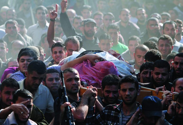 Palestinian mourners carry the body of Hamas' top military commander Ahmed Jabari, killed in an Israeli strike on Wednesday, during his funeral in Gaza City, Thursday, Nov. 15, 2012. Israel barraged the Gaza Strip with airstrikes and shelling Wednesday and killed the Hamas military chief in a targeted strike, launching a campaign aimed at stopping rocket attacks from Islamic militants. The assault killed 10 other Palestinians, including two children and seven militants. On Thursday, militant rockets fired into Israel killed three Israelis, raising the likelihood of a further escalation. (AP Photo/Hatem Moussa)