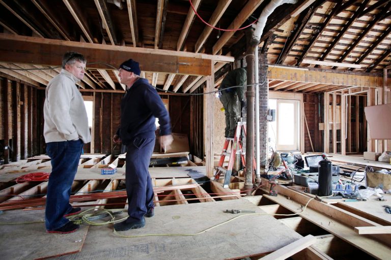   In a Thursday, Dec. 20, 2012 photo, Joseph O'Grady, left, with Rockaway Reach, talks with Kevin Murphy as they discuss the renovation of Murphy's home in the Belle Harbor neighborhood of New York. Murphy's house was heavily damaged by flooding sea water during Superstorm Sandy on Oct. 29, 2012. More than 160 organizations and counting have gotten shares of the Sandy relief funds collected so far by the Robin Hood Foundation. Rockaway Reach works on behalf of Catholic Charities of San Diego, which has received funding from the Robin Hood Foundation. (AP Photo/Mark Lennihan)  