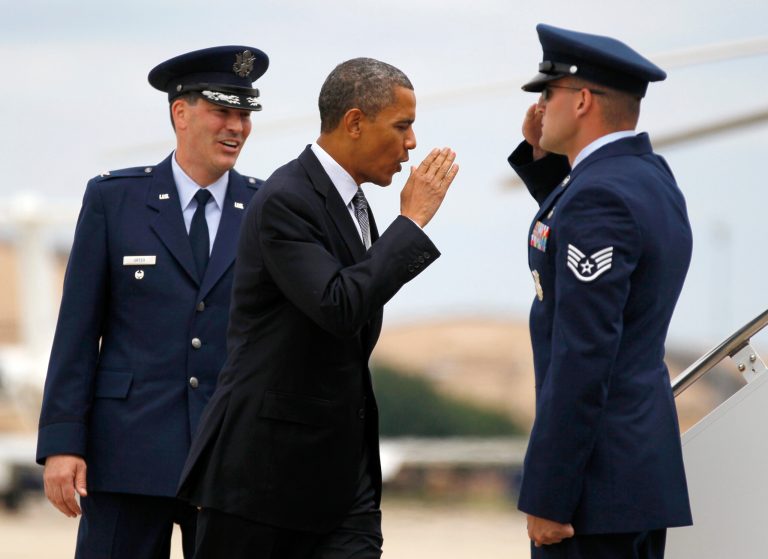   President Barack Obama returns a salute as he walks from Marine One with Col. Greg Urtso, , left, to board Air Force One, Thursday, June 14, 2012, at Andrews Air Force Base, Md., en route to Ohio. (AP Photo/Carolyn Kaster)  