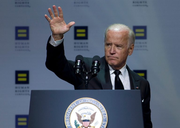 Joe Biden walked onstage Saturday night to a standing ovation and thunderous applause from the largest LGBT advocacy group in the nation. (AP Photo)