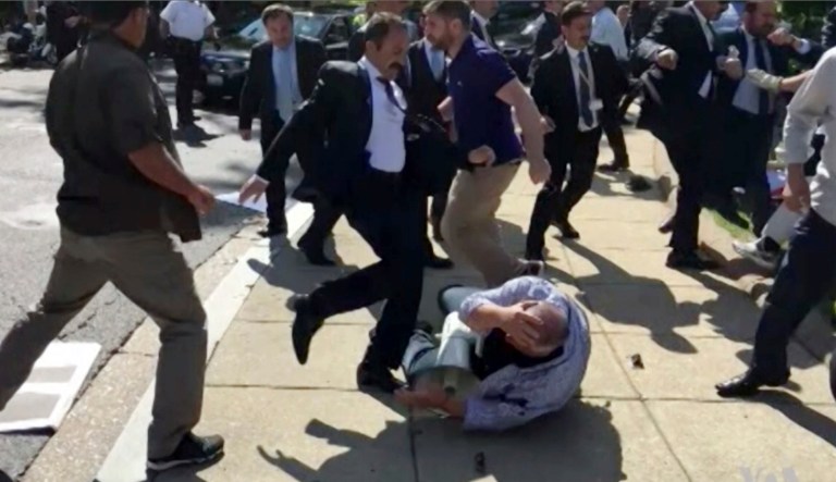 The defendants attacked the peaceful demonstrators outside of the Turkish embassy in May. (Voice of America via AP)