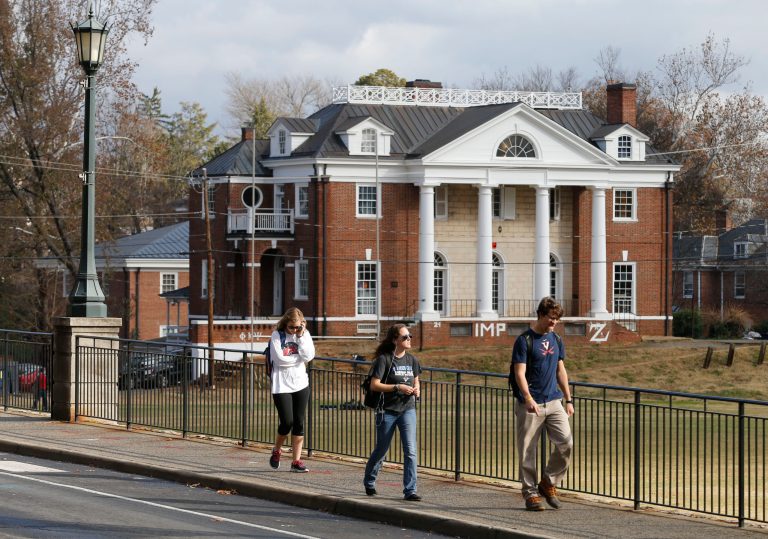 In this Monday, Nov. 24, 2014, file photo, University of Virginia students walk to campus past the Phi Kappa Psi fraternity house at the University of Virginia. (AP Photo)Â 