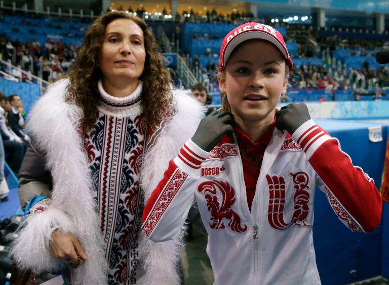 Julia Lipnitskaia of Russia, right, leaves the ice after competing in the women's team free skate figure skating competition at the Iceberg Skating Palace during the 2014 Winter Olympics, Sunday, Feb. 9, 2014, in Sochi, Russia. (AP Photo/Darron Cummings, Pool)