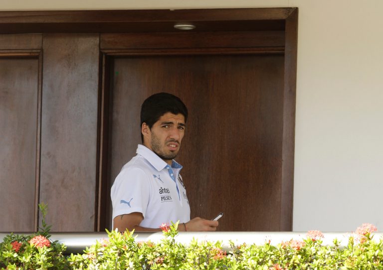 Uruguay's Luis Suarez uses his cell phone at a hotel in Natal, Brazil, Wednesday, June 25, 2014. Suarez bit Italian player Giorgio Chiellini during Uruguay's game with Italy on Tuesday, which could lead to Suarez being kicked out of the World Cup. (AP Photo/Hassan Ammar)