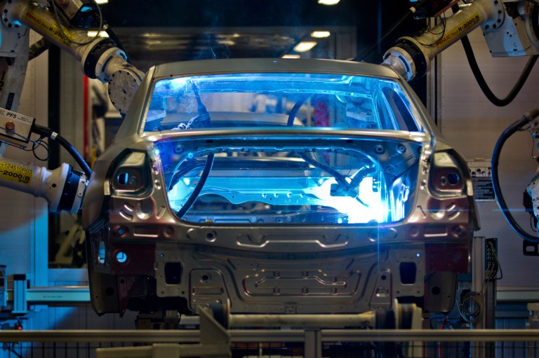 Robotic arms weld the interior of a Volkswagen Passat sedan at the German automaker's plant in Chattanooga, Tenn. (AP Photo/Erik Schelzig)