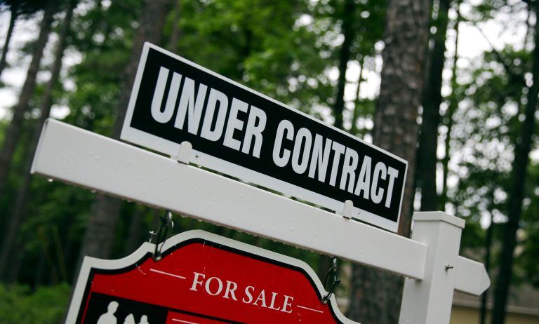 In this June 4, 2015, photo, a real estate sign is posted in front of a newly constructed luxury home in Roswell Ga.Â The Supreme Court last week ruled 5-4 that 