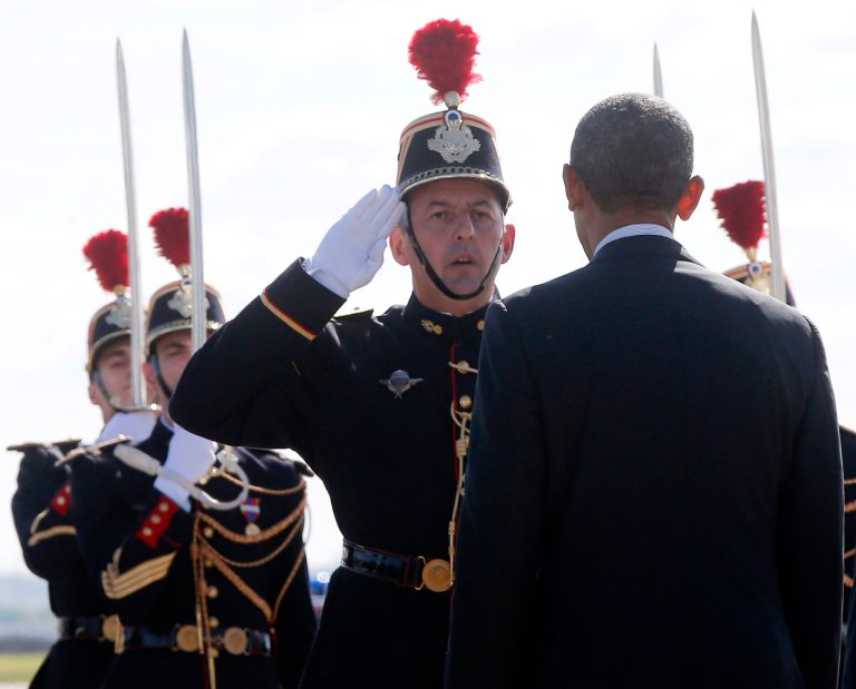President Barack Obama is saluted by Platoon Commander Jean-Philippe Sauvaigo as he arrives at Orly Airport in Paris, France, Thursday, June 5, 2014. He will have dinner with French President Francois Hollande Thursday evening and attend 70th anniversary of D-Day at Normandy on Friday. (AP Photo/Charles Dharapak)