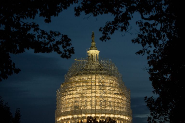 Evening arrives at the Capitol building, covered in scaffolding for major repairs, on Capitol Hill in Washington D.C. Today's elections will decide which party will lead the Senate. (Photo by Allison Shelley/Getty images)