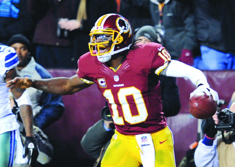 Nick Wass/AP
Robert Griffin III wasn't sharp -- he finished with only 100 yards passing -- but he ran for 63 more and a touchdown as the Redskins clinched the NFC East by beating the Cowboys.