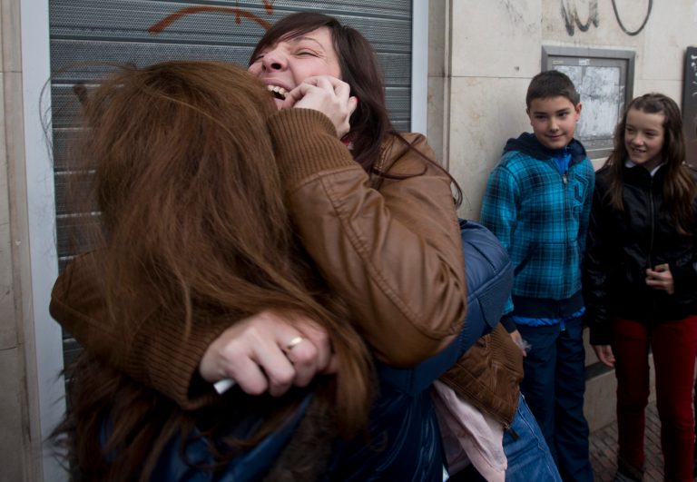   Azahara, right, hugs her mother after winning the main Christmas lottery prize âEl Gordoâ (âThe Fat Oneâ) in Alcala de Henares, just outside of Madrid, Saturday Dec. 22, 2012. Lucky winners of Spainâs cherished Christmas lottery, the worldâs richest, celebrated Saturday, as initial indicators show more than a dozen locations where lucky tickets were sold, each picking up the maximum prize of euro 400,000 (US dlrs 529,840), and some thousands of tickets yielding smaller prizes. (AP Photo/Paul White)  
