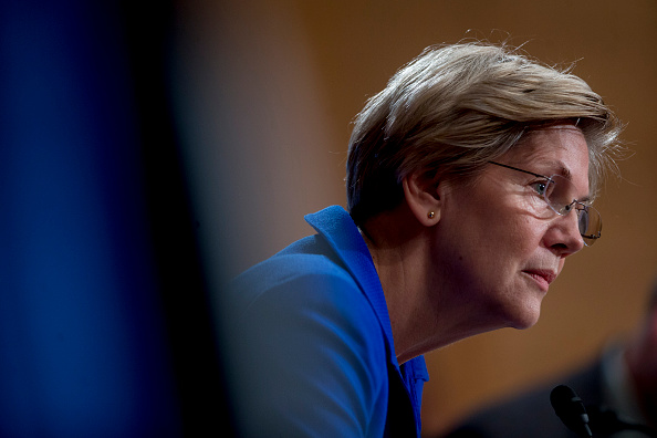 Senator Elizabeth Warren, a Democrat from Massachusetts, listens during a Senate Banking Subcommittee hearing with William C. Dudley, president and chief executive officer of the Federal Reserve Bank of New York, not pictured, in Washington, D.C., U.S., on Friday, Nov. 21, 2014. (Andrew Harrer/Bloomberg via Getty images)