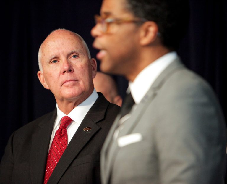 Joe Klinger, Assistant Director at Illinois Emergency Management Agency, left, listens as Illinois Department of Public Health Director LaMar Hasbrouck speaks at a news conference about the state's preparedness for Ebola, Wednesday, Oct. 8, 2014, in Chicago. Hasbrouck promised to keep the public informed of any suspected cases during a news conference held on the same day Dallas health officials announced that the first patient diagnosed in the United States had died. (AP Photo/Sun-Times Media, Michael Jarecki)