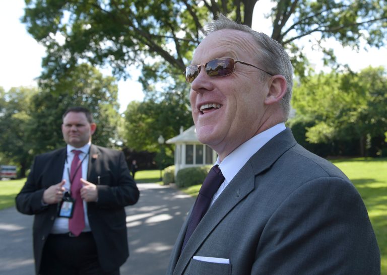 Press Secretary Sean Spicer waits on the South Lawn of the White House in Washington for President Donald Trump to leave, Friday, June 9, 2017. Trump is heading to Bedminster, N.J., for the weekend. (AP Photo/Susan Walsh)