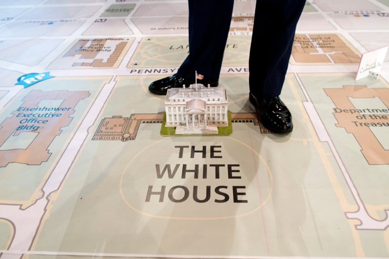   A member of Joint Task Force-National Capital Region stands over a model of the White House on a giant map during a media tour highlighting inaugural preparations being made by military and civilian planners, Wednesday, Dec. 12, 2012, at the DC Armory in Washington. (AP Photo/ Evan Vucci)  