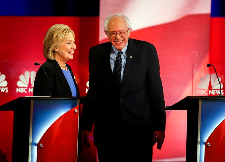 Democratic presidential candidates Hillary Clinton and Sen. Bernie Sanders speak during a break at the Democratic presidential debate. Sanders seems to be racing past Clinton, but one pollster says not so fast. (AP Photo/Stephen B. Morton)