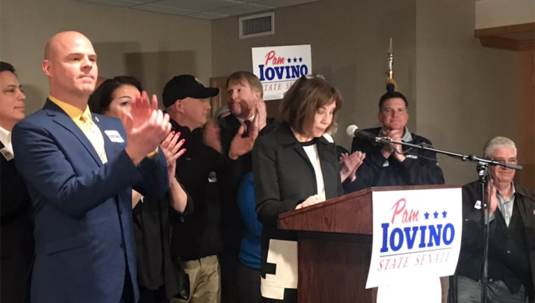 Darrin Kelly, far left, standing on stage with Pam Iovino as she declares victory in the Pennsylvania state Senate 37th District special election.