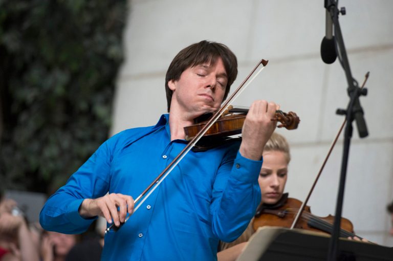 Acclaimed violinist Joshua Bell performs with young musicians who are alumni of the National YoungArts Foundation (YoungArts) during a performance, Tuesday, Sept. 30, 2014, at Union Station in Washington. Seven years ago, Bell performed incognito for tips in a Washington subway station, but almost no one stopped to listen. The subway performance was an experiment with The Washington Post to see if anyone would notice some of the world's great music during their rush to work. It made for a good story that eventually won the Pulitzer Prize and inspired a children's book and even mentions in church sermons.  (AP Photo/Molly Riley)