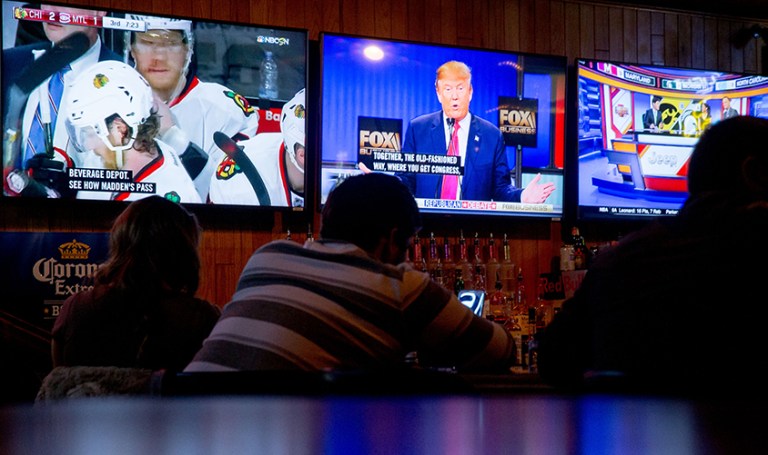 Republican presidential candidate Donald Trump is seen on a television at Wellman's Pub in Des Moines, Iowa, Thursday, Jan. 14, during a GOP presidential debate. The election has damaged voters' perceptions of both parties, but the Republicans have taken a bigger blow than Democrats. (AP Photo/Andrew Harnik)