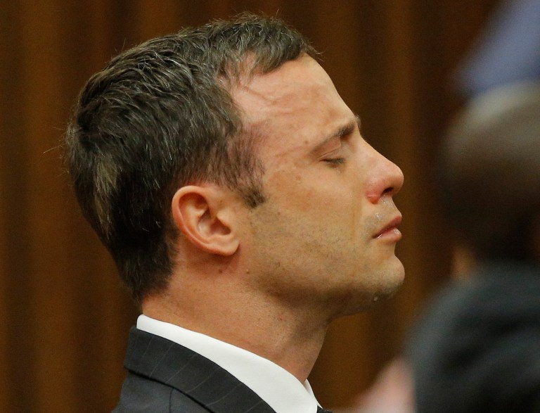 Oscar Pistorius reacts in the dock as Judge Thokozile Masipa delivers her verdict during his murder trial in Pretoria, South Africa, Thursday Sept. 11, 2014. Masipa ruled out a murder conviction for the double-amputee Olympian in the shooting death of his girlfriend, Reeva Steenkamp, but said he was negligent, raising the possibility he'll be convicted of culpable homicide. (AP Photo/Kim Ludbrook, Pool)