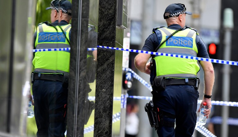 Australian police said on Tuesday that a shootout in which two men died, three police officers were wounded and a female hostage was freed was being treated as a terror attac (AP Photo/Andrew Brownbill)