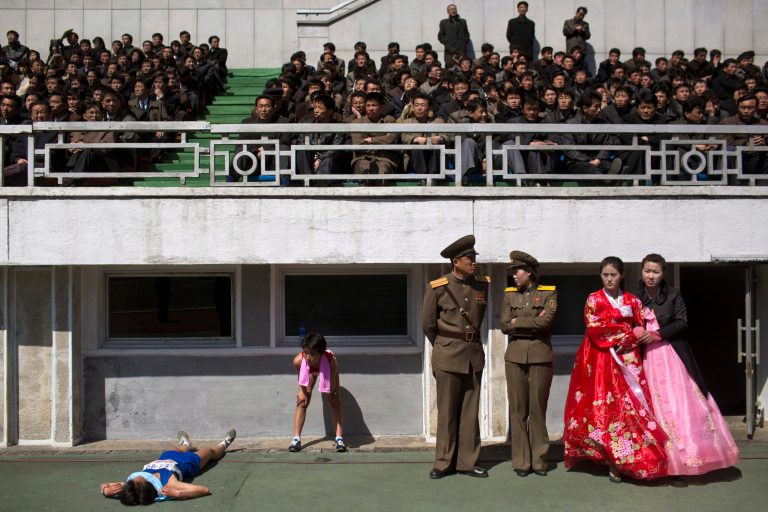 Runners rest inside Kim Il Sung Stadium in Pyongyang, North Korea on Sunday, April 14, 2013. North Korea hosted the 26th Mangyongdae Prize Marathon to mark the upcoming April 15, 2013 birthday of the late leader Kim Il Sung. (AP Photo/David Guttenfelder)