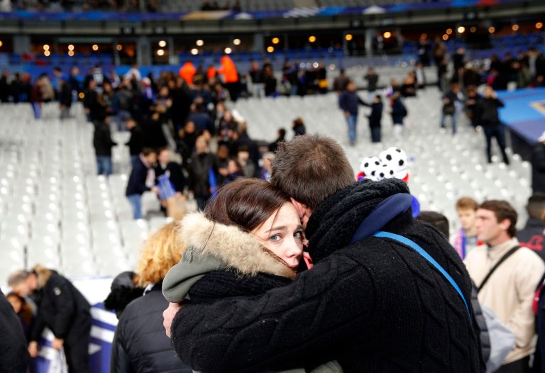 A supporter comforts a friend after invading the pitch of the Stade de France stadium at the end of the international friendly soccer match between France and Germany in Saint Denis, outside Paris. (AP Photo/Christophe Ena)