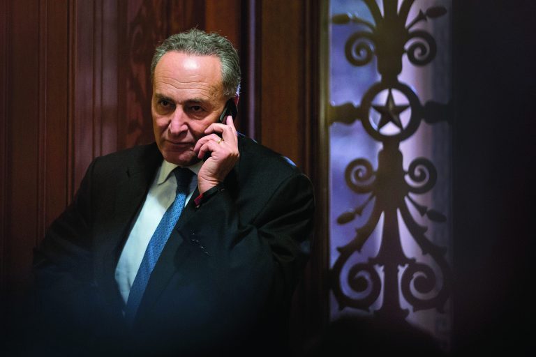 Sen. Charles Schumer, D-N.Y., third ranking in the Senate Democratic leadership, speaks on his cell phone following a closed-door caucus at the Capitol in Washington, Sunday, Dec. 30, 2012 to discuss how to avoid the 
