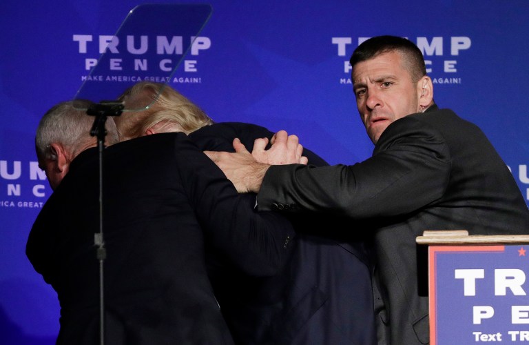 Members of the Secret Service rush Republican presidential candidate Donald Trump off the stage at a campaign rally in Reno, Nev., on Saturday, Nov. 5, 2016. (AP Photo/John Locher)