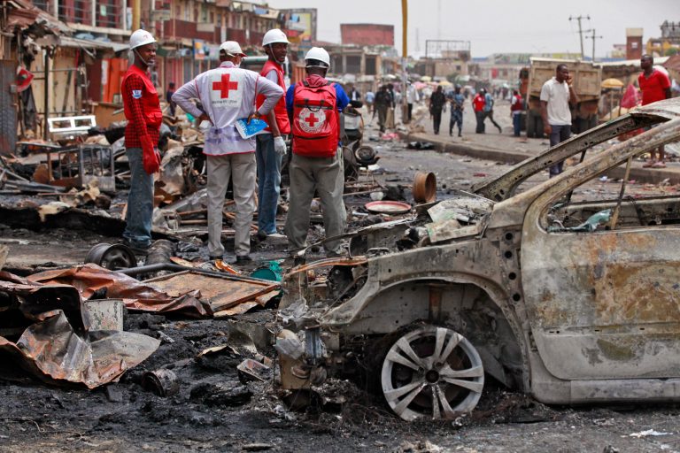 FILE-In this file photo taken on Wednesday, May 21, 2014, Red Cross personnel search for remains at the site of one of Tuesday's car bombs in Jos, Nigeria.  Boko Haram militants are taking over villages in northeastern Nigeria, killing and terrorizing civilians and political leaders, witnesses say, as the Islamic fighters make a comeback from a year-long military offensive aimed at crushing them.  (AP Photo/Sunday Alamba, File)