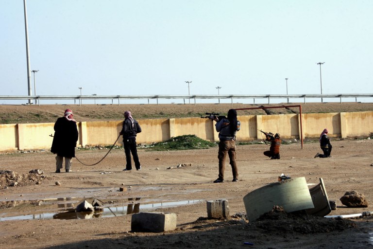 Gunmen patrol in Fallujah, west of Baghdad, Iraq, Sunday. Iraqi forces have yet to militarily try to reassert control over Fallujah, which remains in the hands of the militants and tribal gunmen opposed to the central government. Militants and tribal fighters also control part of the provincial capital, Ramadi. Sporadic clashes there and in surrounding areas continue to take place. (AP Photo)