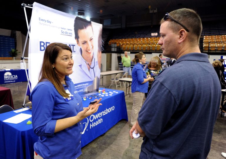FILE - In this Tuesday, Oct. 1, 2013, file photo, registered nurse Salanda Bowman, left, talks with part-time Kentucky Wesleyan College student Jason Ward, of Whitesville, about job openings at the Owensboro Health Regional Hospital during a Regional Career and Job Fair in the Owensboro Sports Center  in Owensboro, Ky. The U.S. economy added just 148,000 jobs in September, suggesting that employers held back on hiring before a 16-day partial government shutdown began Oct. 1. (AP Photo/The Messenger-Inquirer, Gary Emord-Netzley, File)