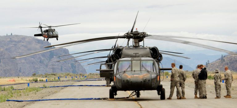 Washington National Guard Black Hawk helicopters are lined up at the airport in Omak, Wash., on Thursday, July 24, 2014. (AP Photo)