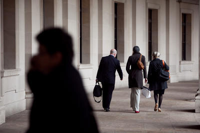 Workers head home near the Federal Triangle Metro station. The D.C. area saw its largest jobs increase in more than a year in May, but the number of federal government jobs is shrinking.