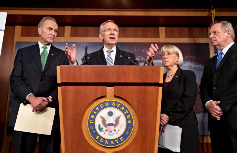Senate Majority Leader Harry Reid, D-Nev.,  speaks with reporters after voting on a measure to avert a threatened Treasury default and reopen the government after a partial, 16-day shutdown, at the Capitol in Washington, Wednesday, Oct. 16, 2013, as Sen. Chuck Schumer, D-N.Y., Sen. Patty Murray, D-Wash., chair of the Senate Budget Committee, and Senate Majority Whip Dick Durbin, D-Ill., listen.   (AP Photo/J. Scott Applewhite)