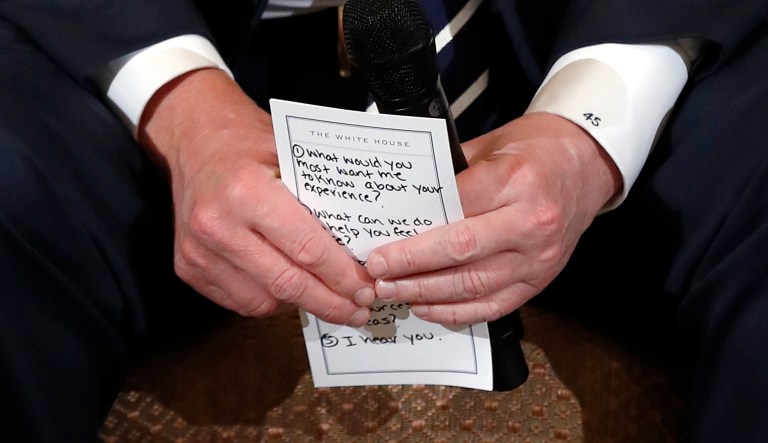President Trump holds notes during a listening session on Wednesday with high school students and teachers in the State Dining Room of the White House in Washington. Trump heard the stories of students and parents affected by school shootings, following last week's deadly shooting in Florida. (AP Photo/Carolyn Kaster)